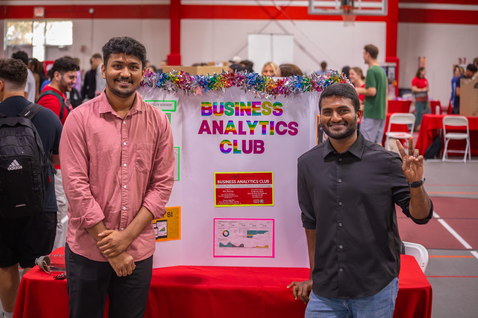 Two students at the Business Analytics Club table during a Lewis University involvement fair