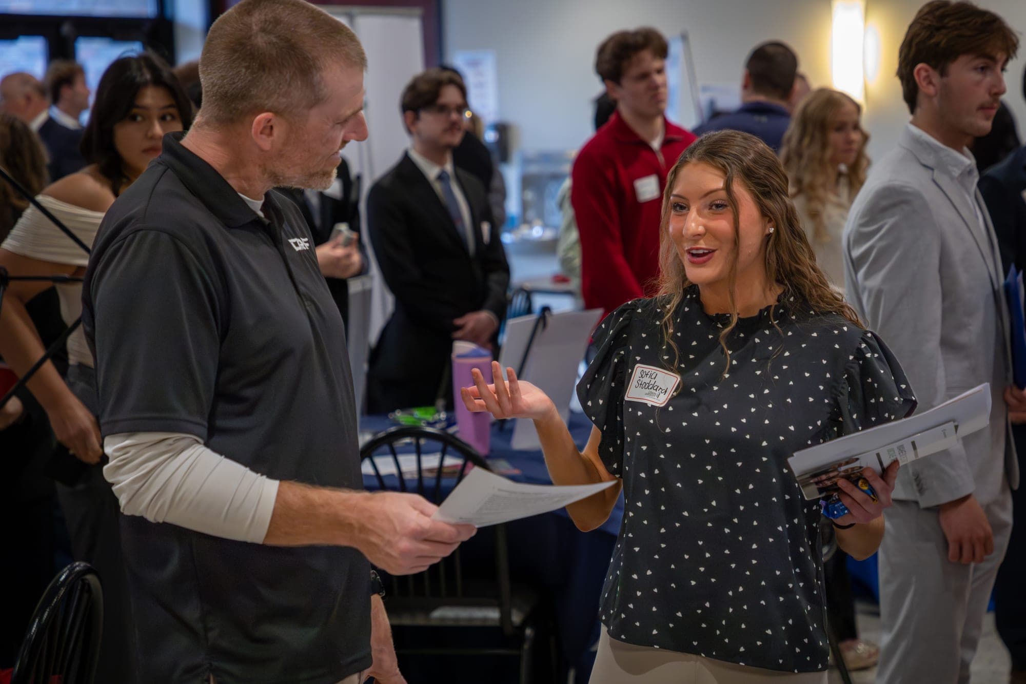 Students and employers talking at a Lewis University networking event