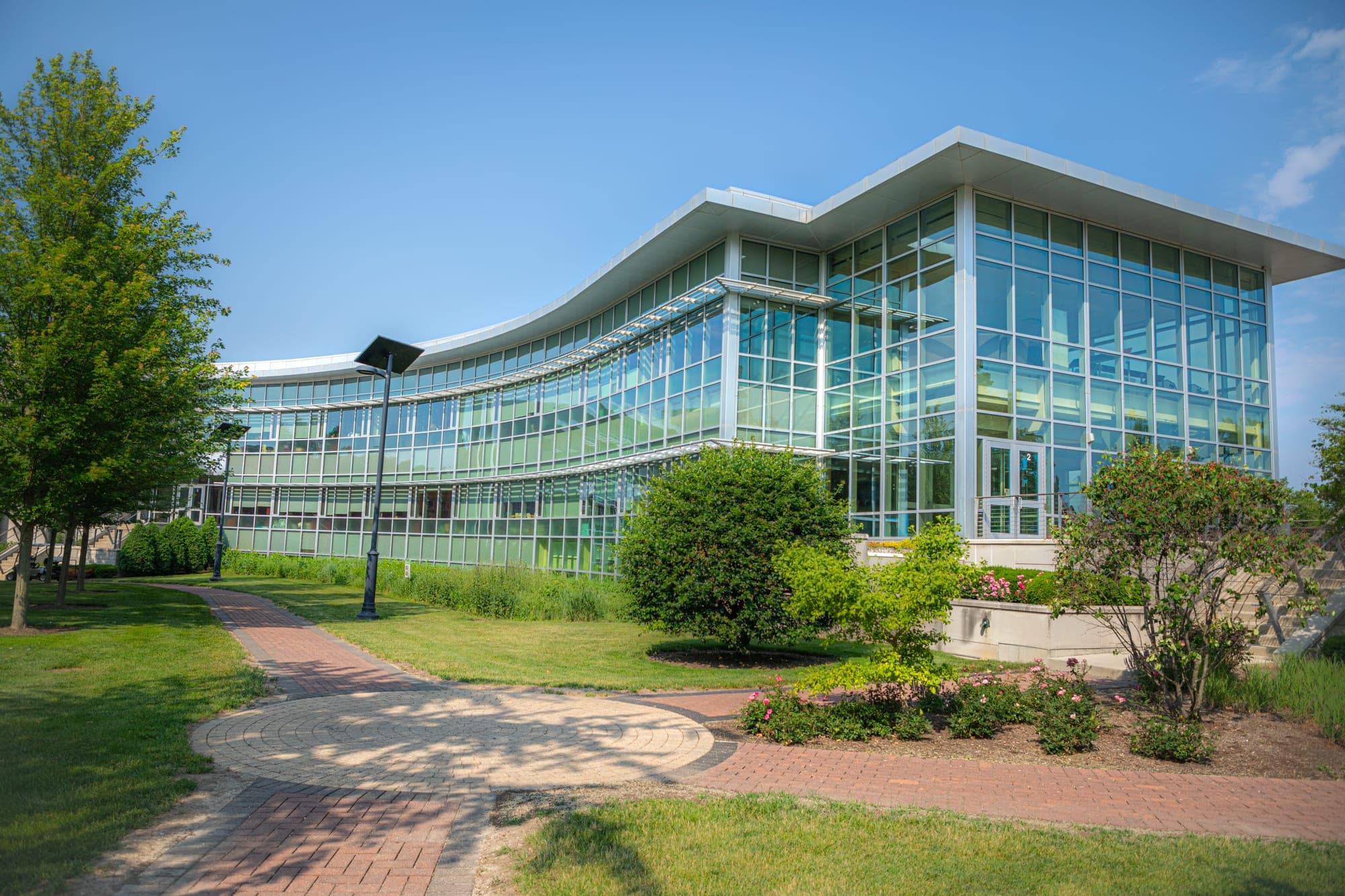 Modern glass academic building on the Lewis University campus in summer