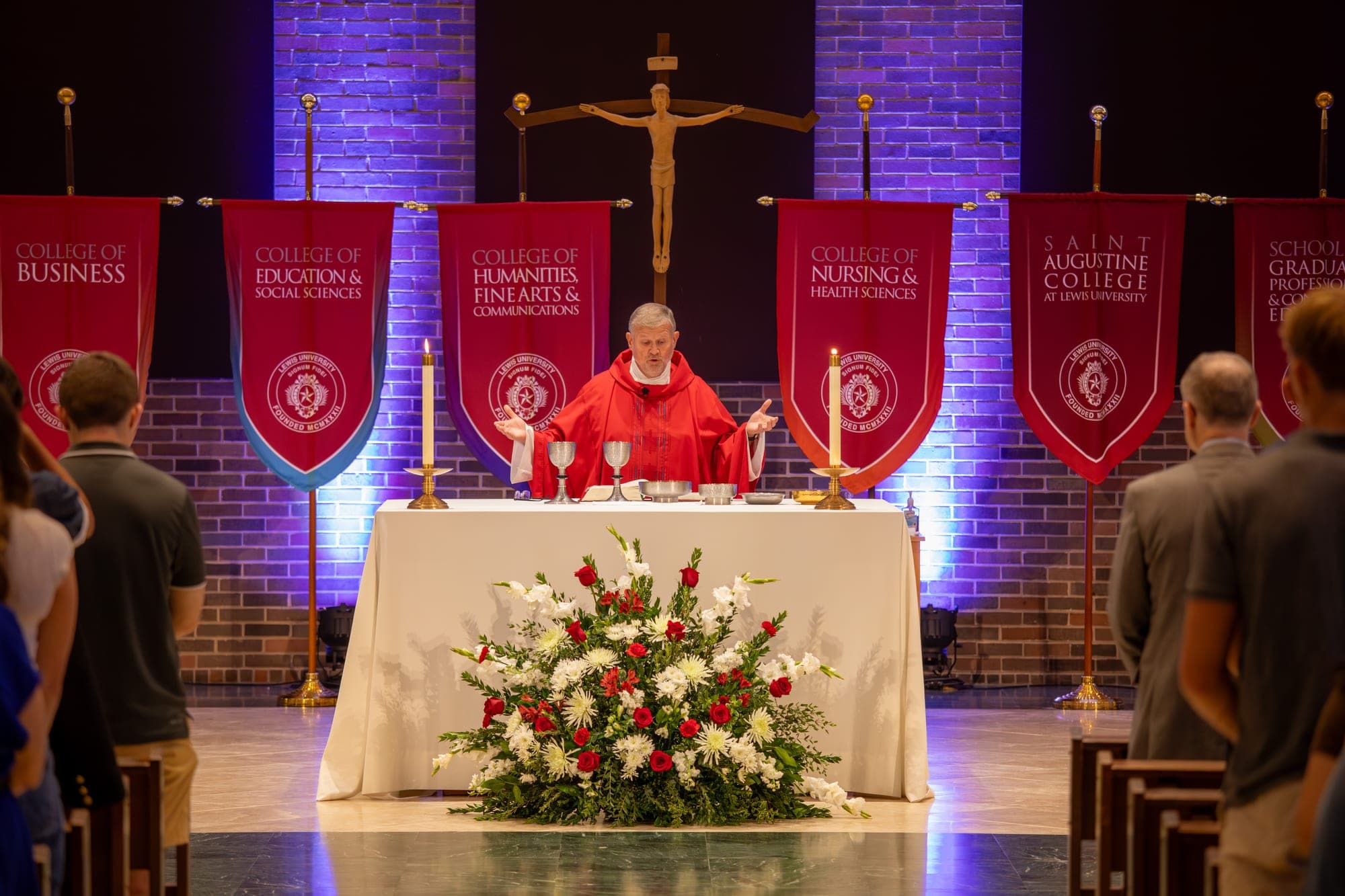 Mass celebrated on stage beneath banners for each Lewis University college